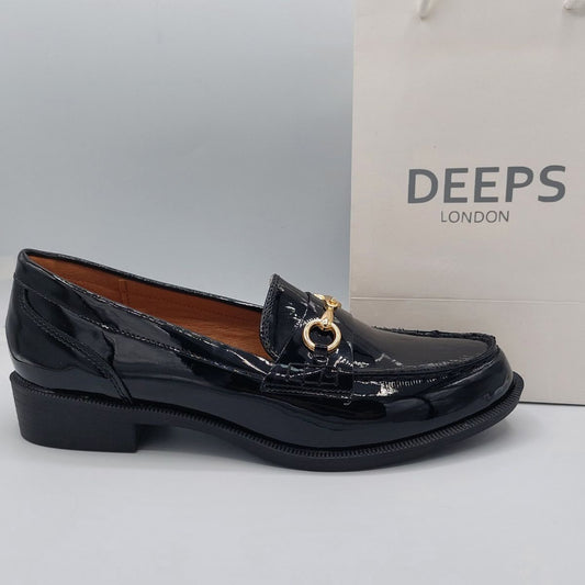 Side view of women's black patent classic slip-on loafer with a gold T-bar detail, a stylish and elegant shoe in London.