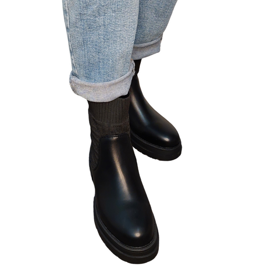 Front view of women's black chunky pull-on Chelsea ankle boots in faux leather, a comfortable and stylish choice for London.