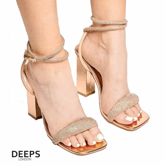 Woman's foot wearing stylish Lushious block heeled sandals with diamante detail tube front strap in Champagne, a fashionable and comfortable choice for London events from DeepsLondon.