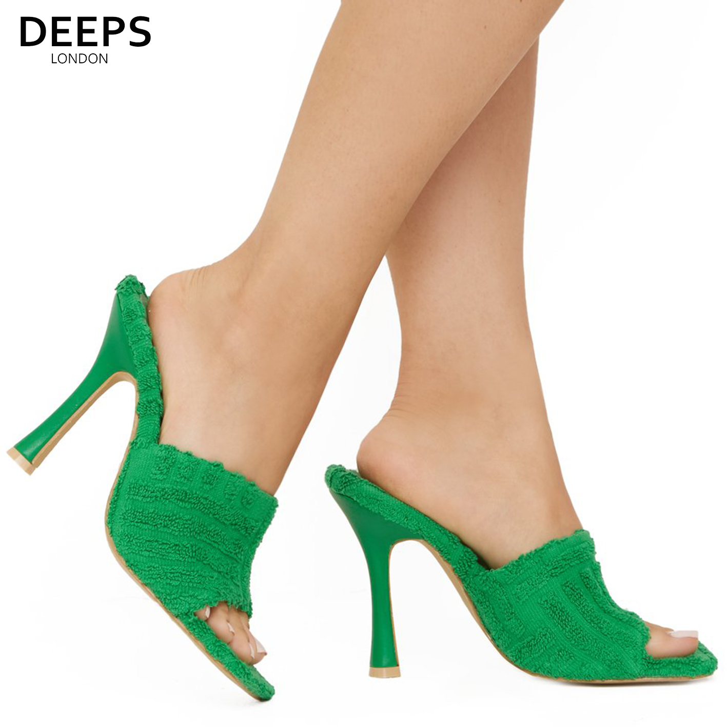 Woman's foot wearing stylish Laila towel fabric mule heels in green, a fashionable and comfortable choice for London days and evenings from DeepsLondon.