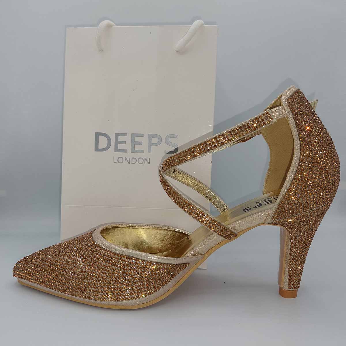 Close-up of the knitted heel and delicate straps on women's Maya court shoes in gold, highlighting their unique and elegant features from DeepsLondon.