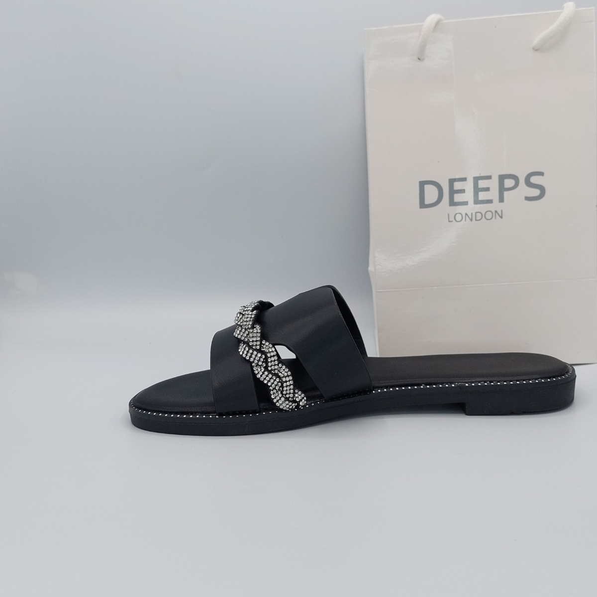 Front profile of sparkly black diamante flats for women festive wear gladiator style 