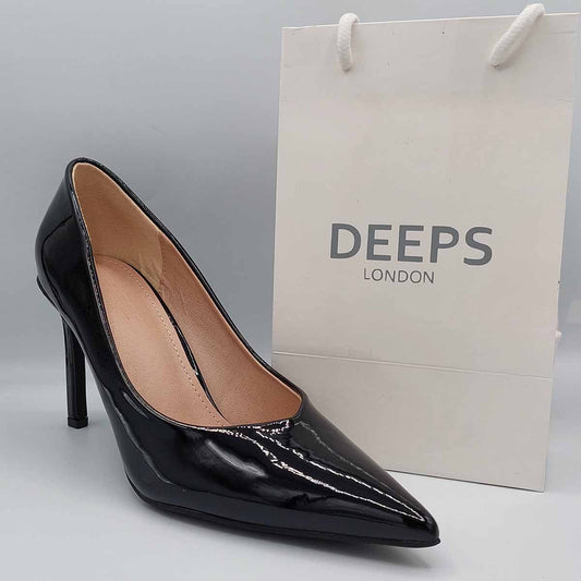Side profile of women's black patent stiletto court shoes, showcasing the sleek patent leather and sharp stiletto heel, perfect for London style.