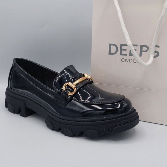 Side profile of women's black patent T-bar platform loafer, showcasing its chunky sole and stylish design, perfect for making a statement in London.
