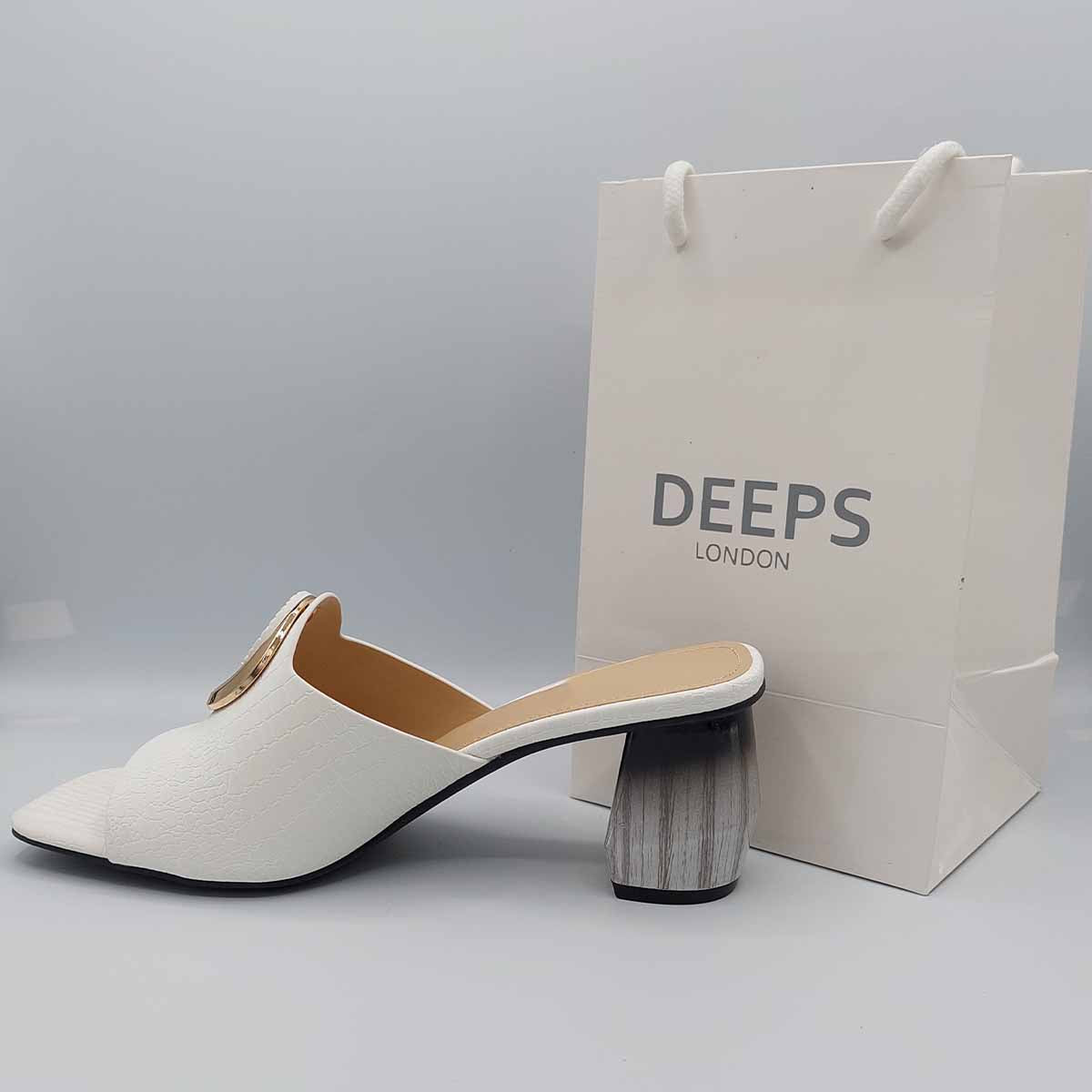 Woman's foot wearing stylish breezy block heel open toe mules in white, a comfortable and fashionable choice for London days from DeepsLondon.