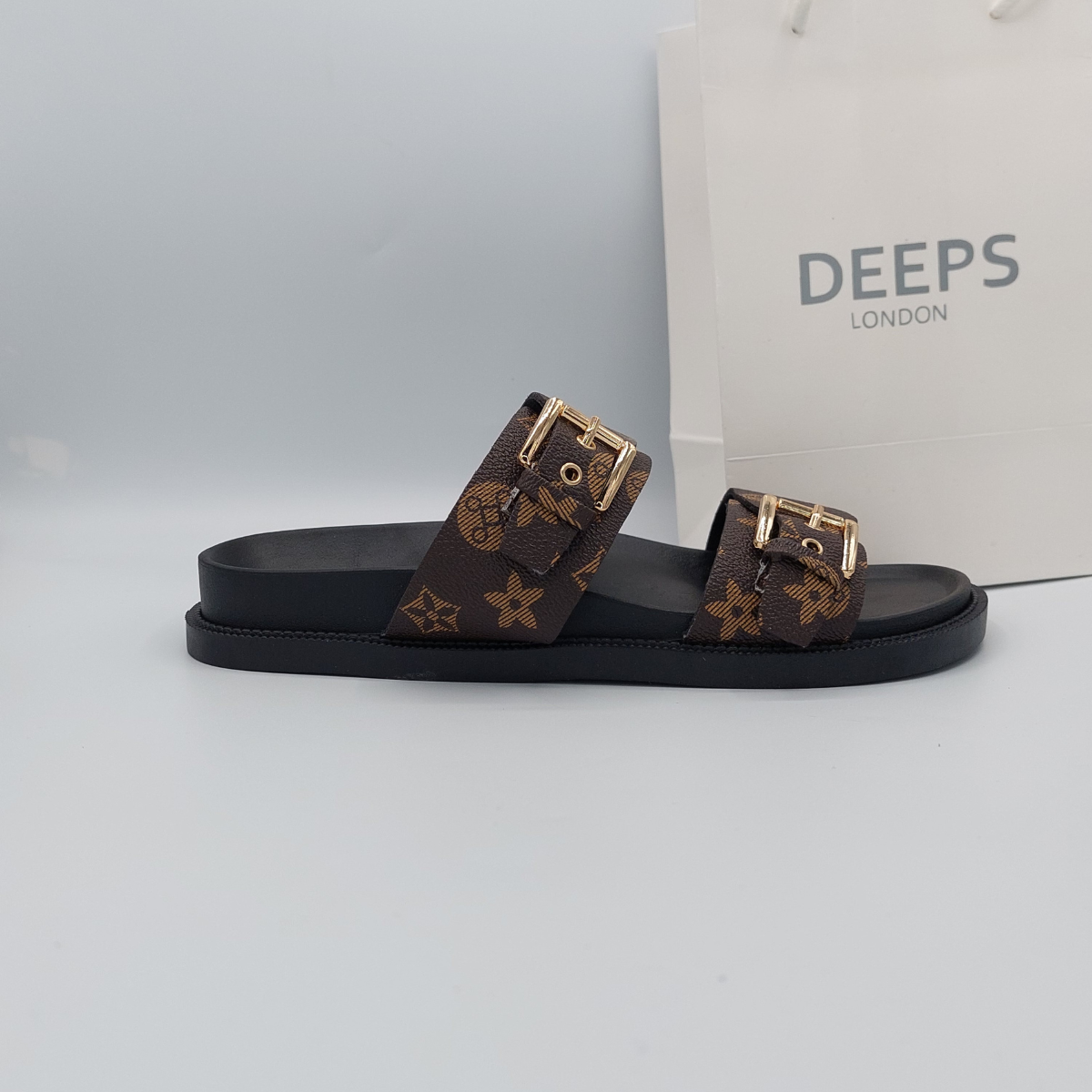 Front view of women's brown print flat slider sandals with double buckle straps