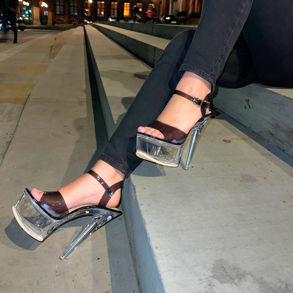 Woman's foot wearing stylish chunky clear platform stiletto high heels in black, a comfortable and fashionable choice for London events from DeepsLondon.
