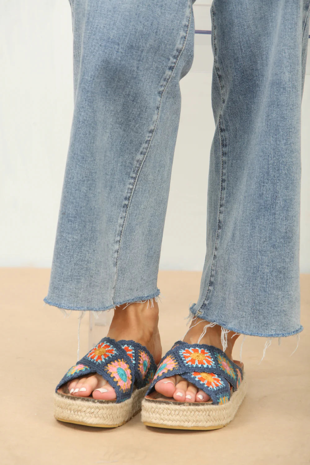 Front view of crochet detail cross strap printed sandals in navy, showcasing the stylish crochet accents and playful print, perfect for holiday wear.