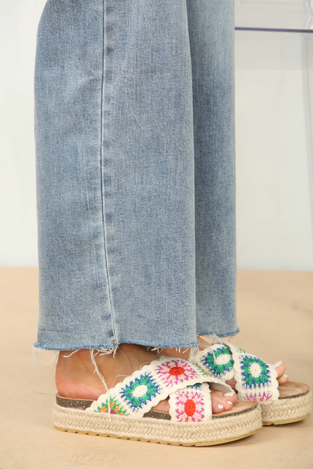 Side profile of crochet detail cross strap printed sandals in white, highlighting the comfortable design and unique strap details, ideal for beach days.