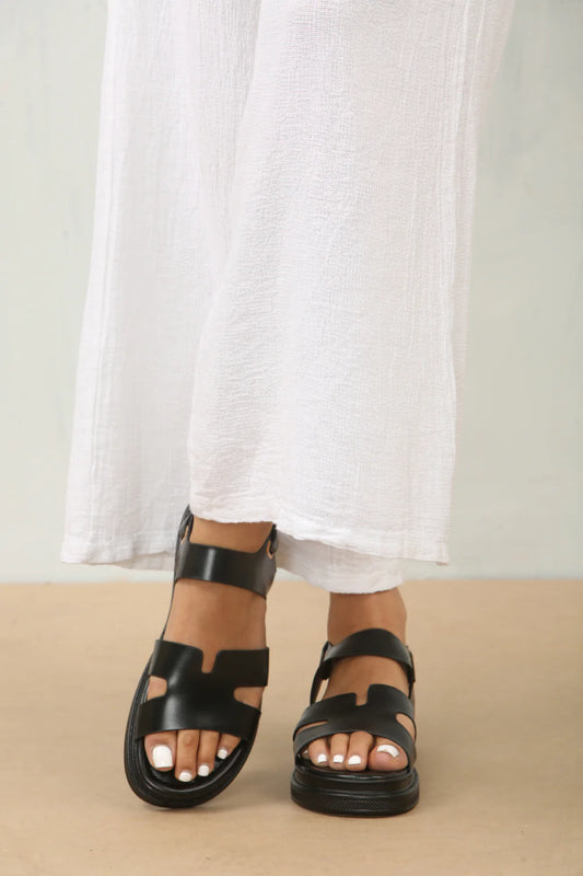 Front view of designer chunky black faux leather sandal, showcasing the bold chunky sole and stylish black straps, London edgy style from DeepsLondon.