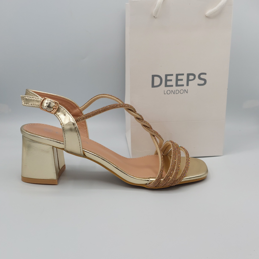 Front view of Deeps London diamante embellished gold block heel sandals with buckle strap, a glamorous and stylish choice.