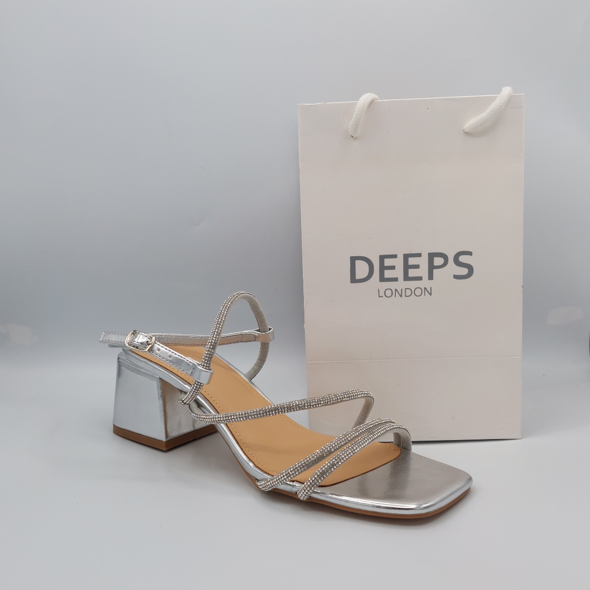 Side profile of diamante embellished block heel sandals, showcasing the block heel and strap detailing for London fashion.