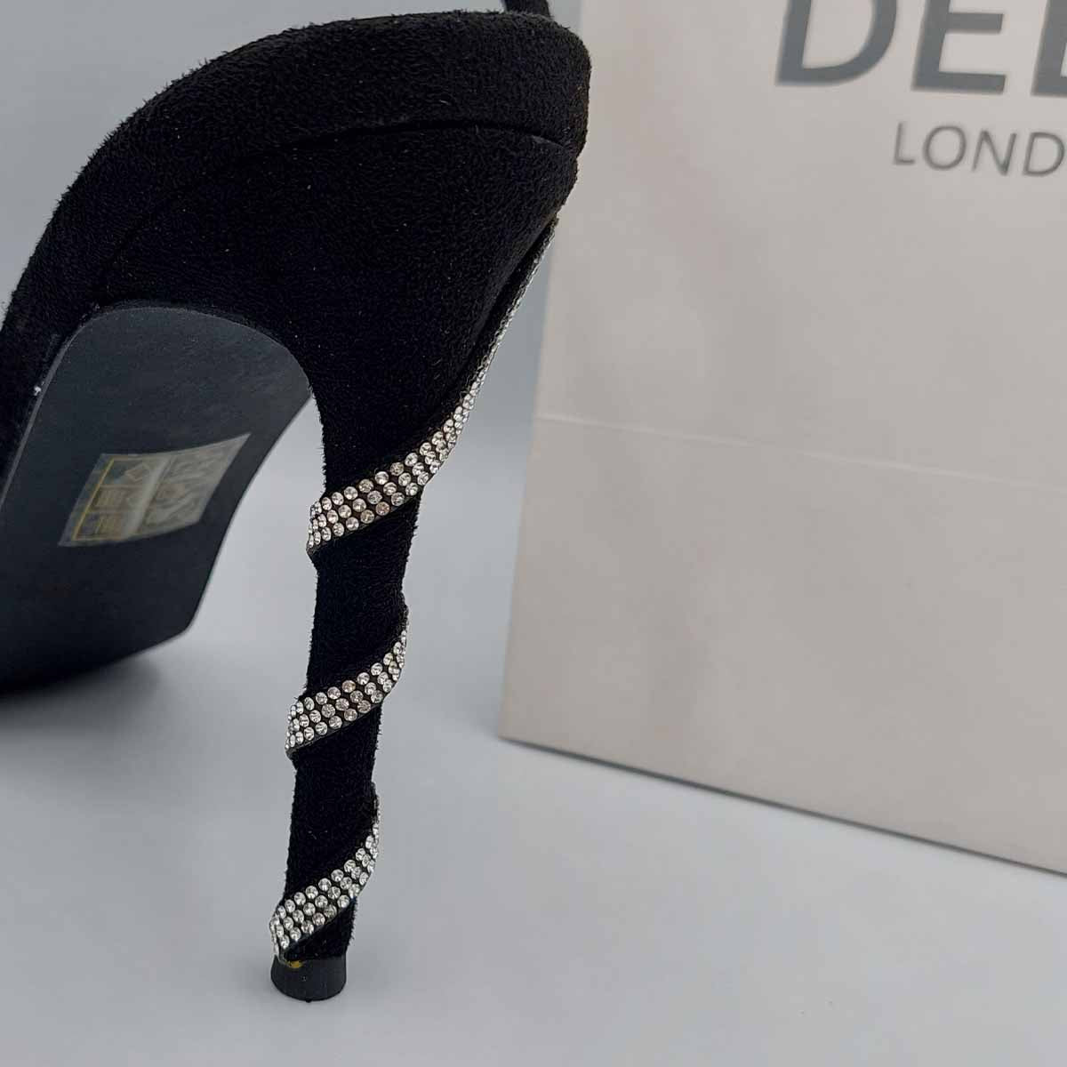 Close-up of the diamante embellishments and spiral wrap strap on stiletto heels in black, highlighting their elegant and unique design for London events