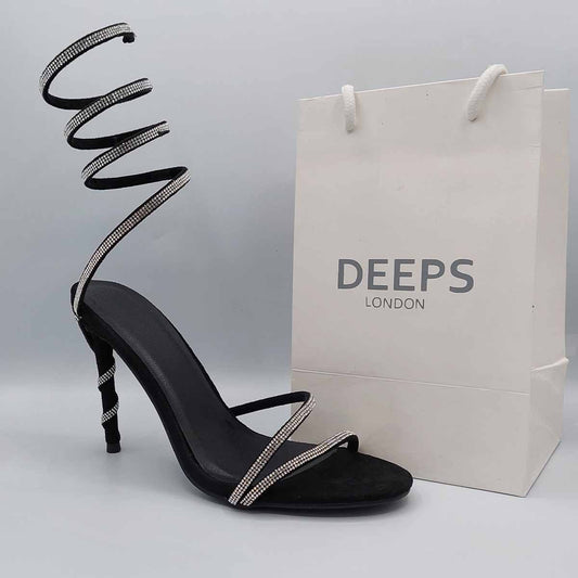Front view of diamante spiral wrap around stiletto heels in black, glamorous women's occasion sandals in London from DeepsLondon.