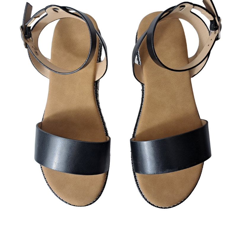 Woman's foot wearing stylish women's espadrille flatform sandals in black, comfortable summer wedges from DeepsLondon in London.