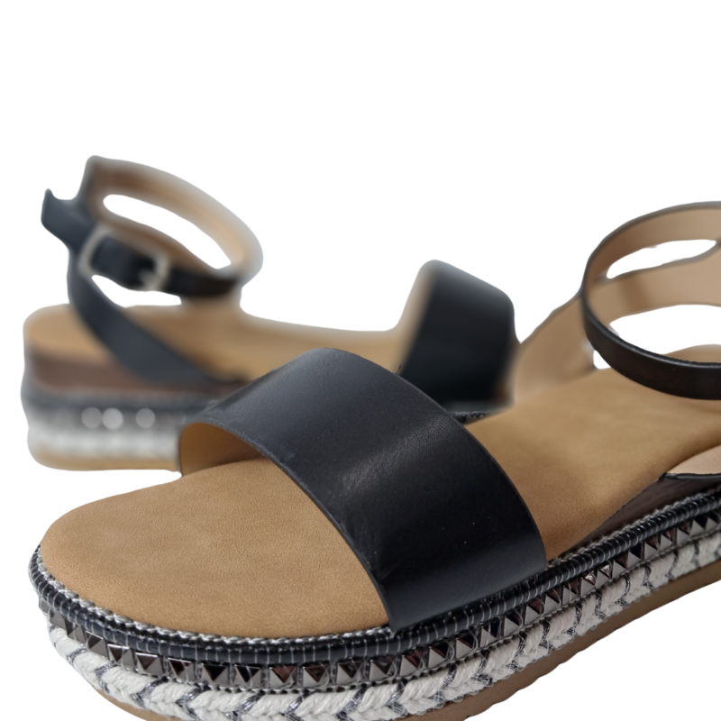 Close-up of the espadrille sole and strap detail on women's flatform sandals in black, stylish summer wedges from DeepsLondon in London.