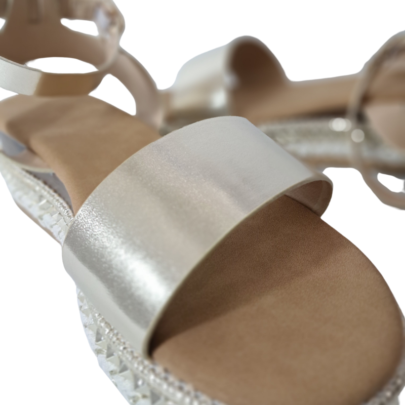 Close-up of the espadrille sole and strap detail on women's flatform sandals in gold, stylish summer wedges from DeepsLondon in London.