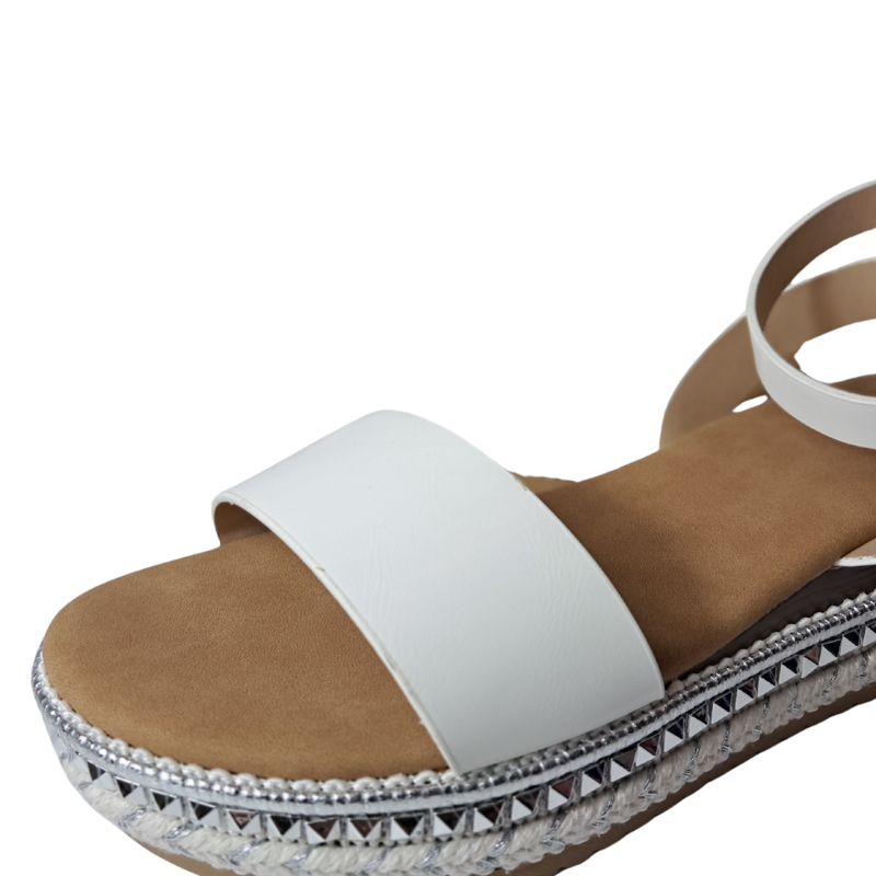 Close-up of the espadrille sole and strap detail on women's flatform sandals in white, stylish summer wedges from DeepsLondon in London.