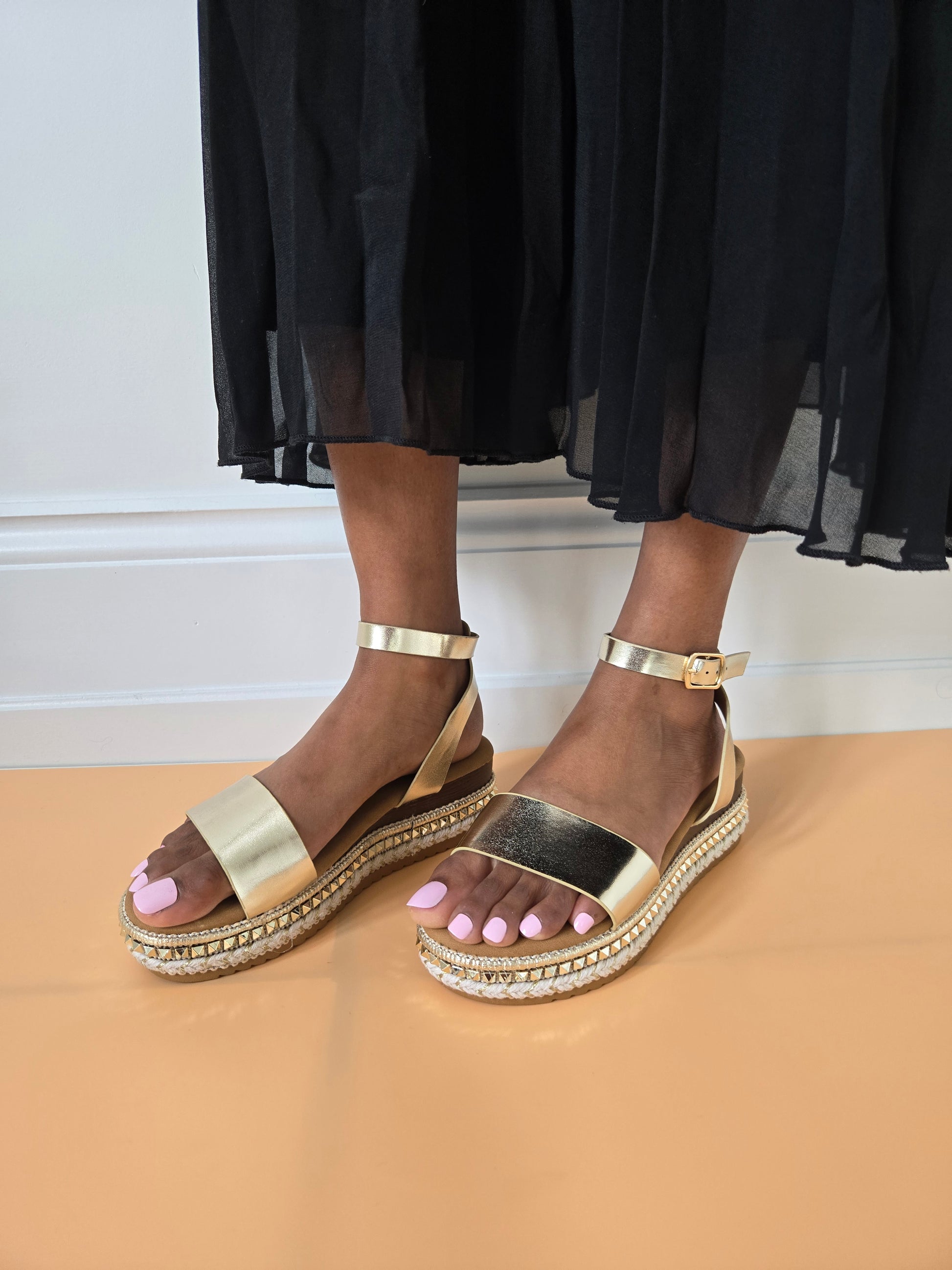 Side view of women's espadrille flatform sandals in gold showcasing the wedge and strap details, stylish summer footwear from DeepsLondon in London.