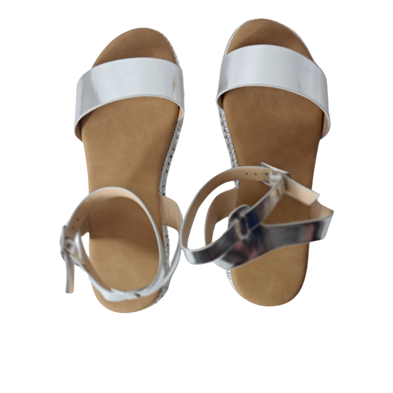 Woman's foot wearing stylish women's espadrille flatform sandals in silver, comfortable summer wedges from DeepsLondon in London.