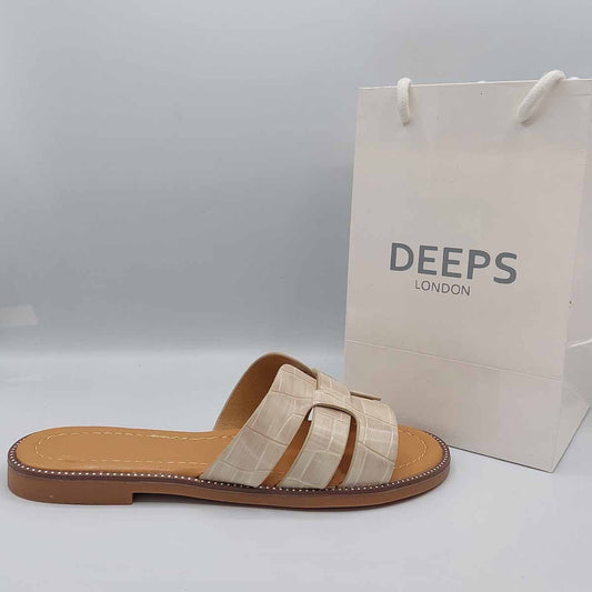 Front view of women's beige faux leather slip-on sliders with a stylish cut-out strap design, perfect for casual wear in London.