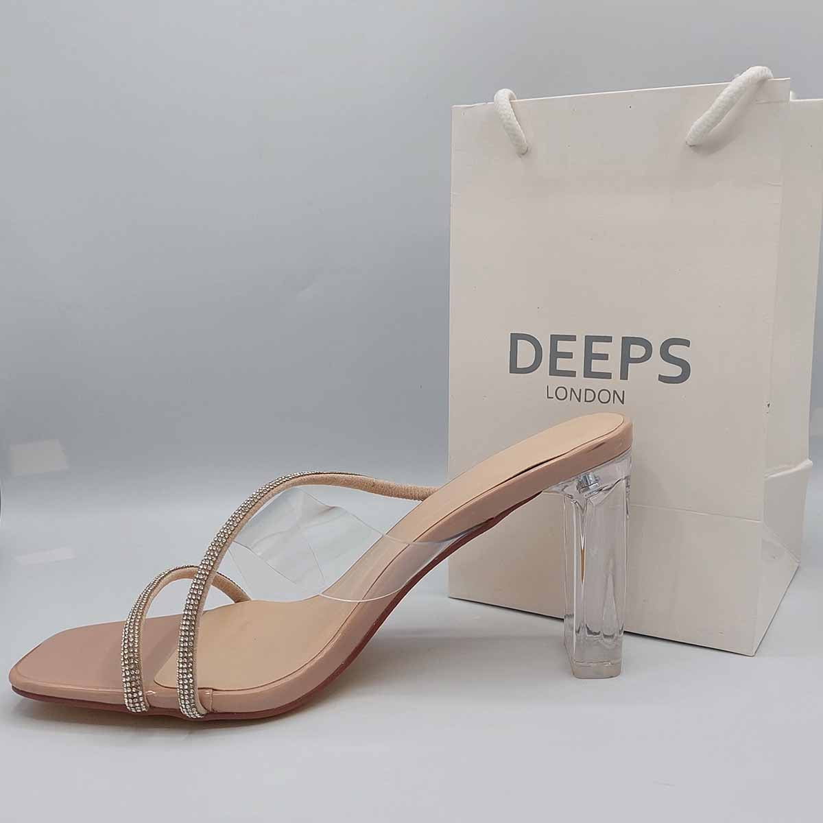 Side profile of Izza diamante clear perspex block heel mules in beige, showcasing the clear block heel and diamante strap detailing for London fashion.