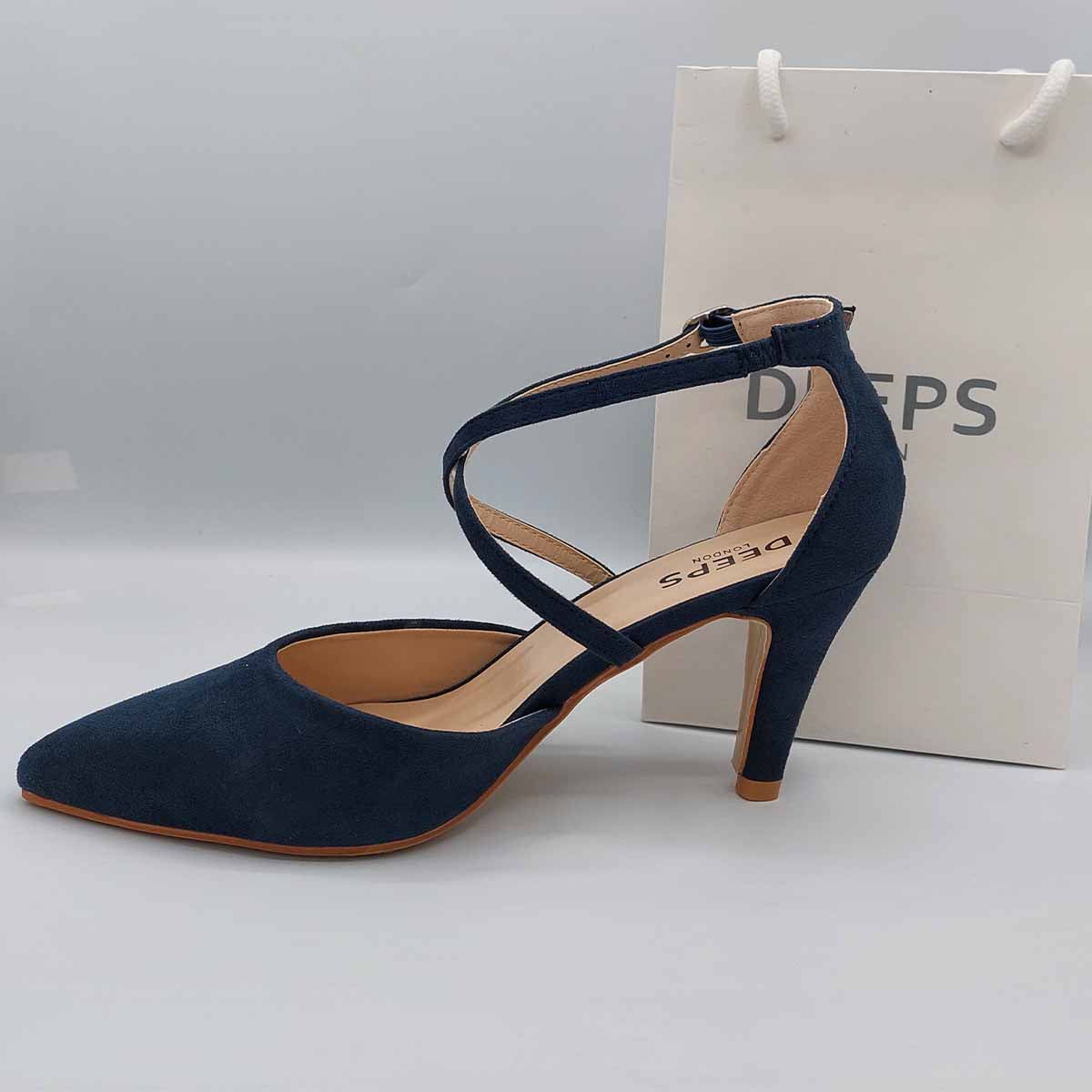Side profile of women's low knitted heel strappy court shoes in navy, showcasing the low knitted heel and delicate strap detailing for London fashion.