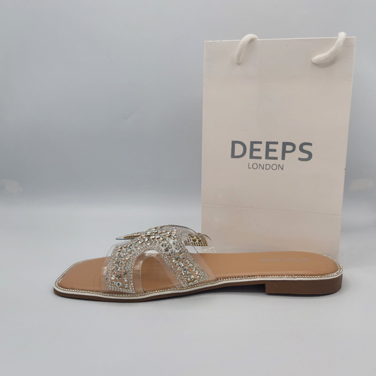 Side profile of women's nude flat slip-on sandals with sparkling diamante straps. party wear shoes