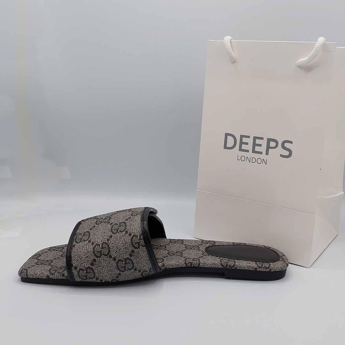 Side profile of women's open toe flat slider sandals in a black print, showcasing their easy slip-on design for London comfort.