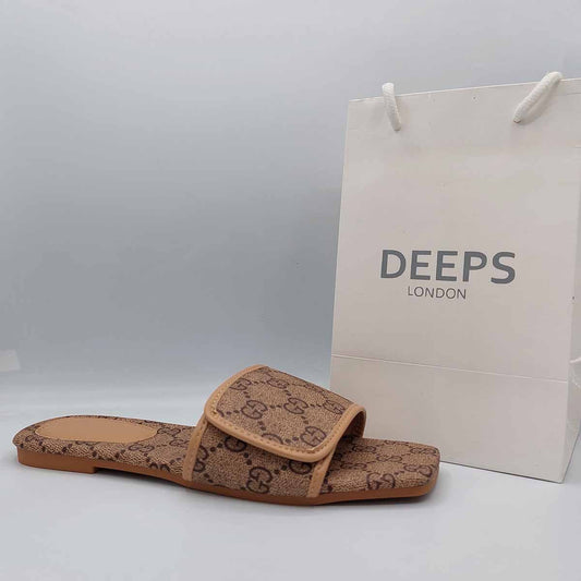 Side profile of women's open toe flat slider sandals in a brown print, showcasing their easy slip-on design for London comfort.
