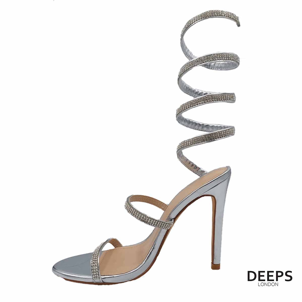 Side profile of diamante spiral wrap around stiletto heels in silver, showcasing the high stiletto heel and spiral wrap detailing for London fashion.