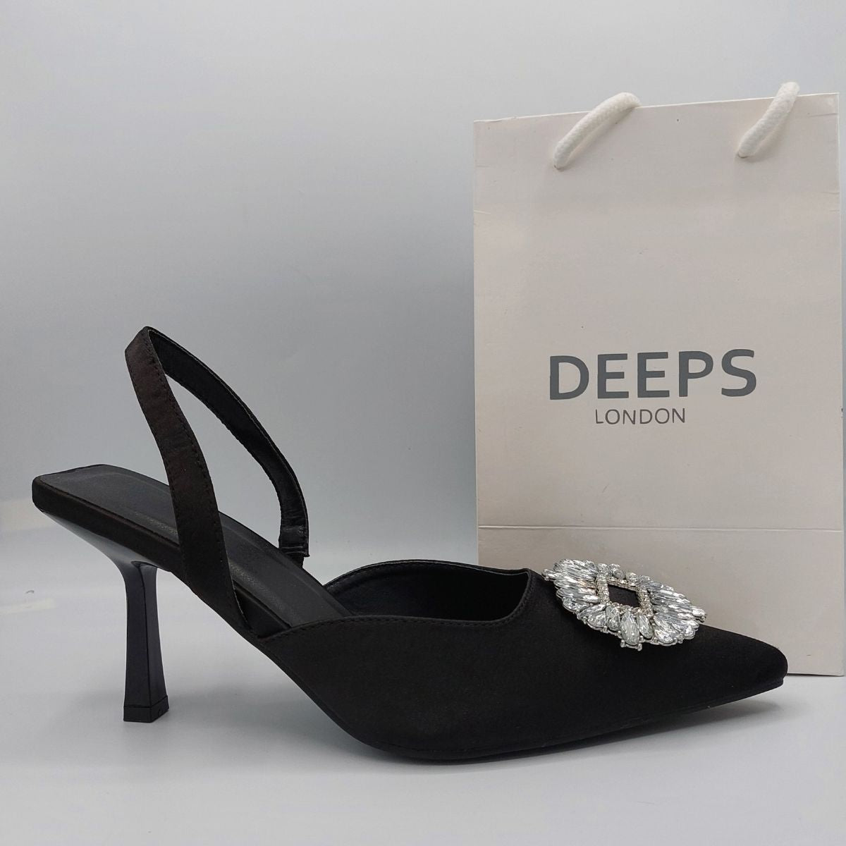 Side profile of women's perspex court shoe with diamante brooch detail in Black Satin, showcasing the perspex material and brooch detailing.