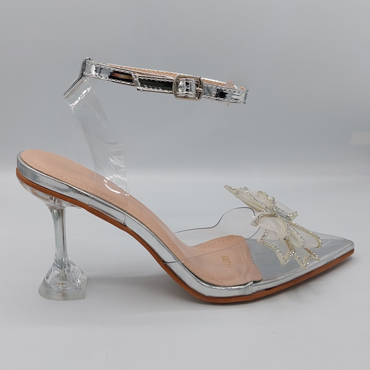 Front view of women's perspex court shoe with diamante brooch detail in silver, an elegant and stylish choice for London occasions.