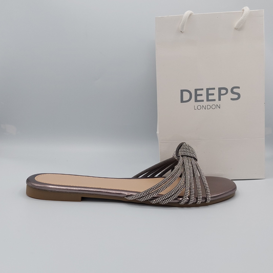 Front view of women's black perspex flat slider sandals with elegant diamante straps, ideal for London style