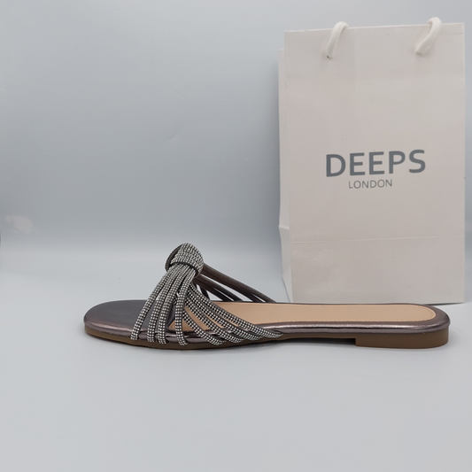 Side profile of black perspex flat slider sandals for women highlighting the delicate diamante embellishments, a sophisticated London look.