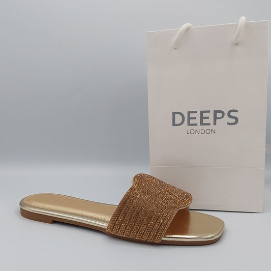 Front view of women's gold perspex flat slider sandals with dazzling diamante straps, perfect for a stylish look in London.