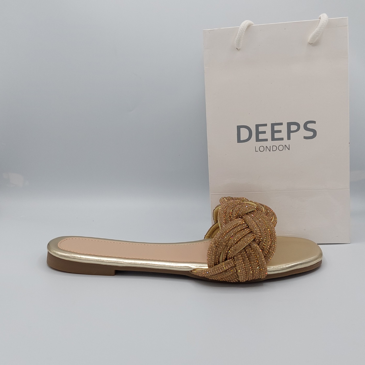 Front view of women's gold perspex flat slider sandals with dazzling diamante straps.