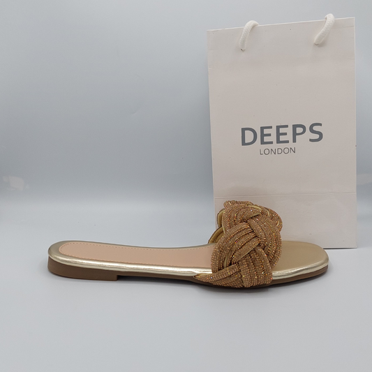 Front view of women's gold perspex flat slider sandals with dazzling diamante straps.