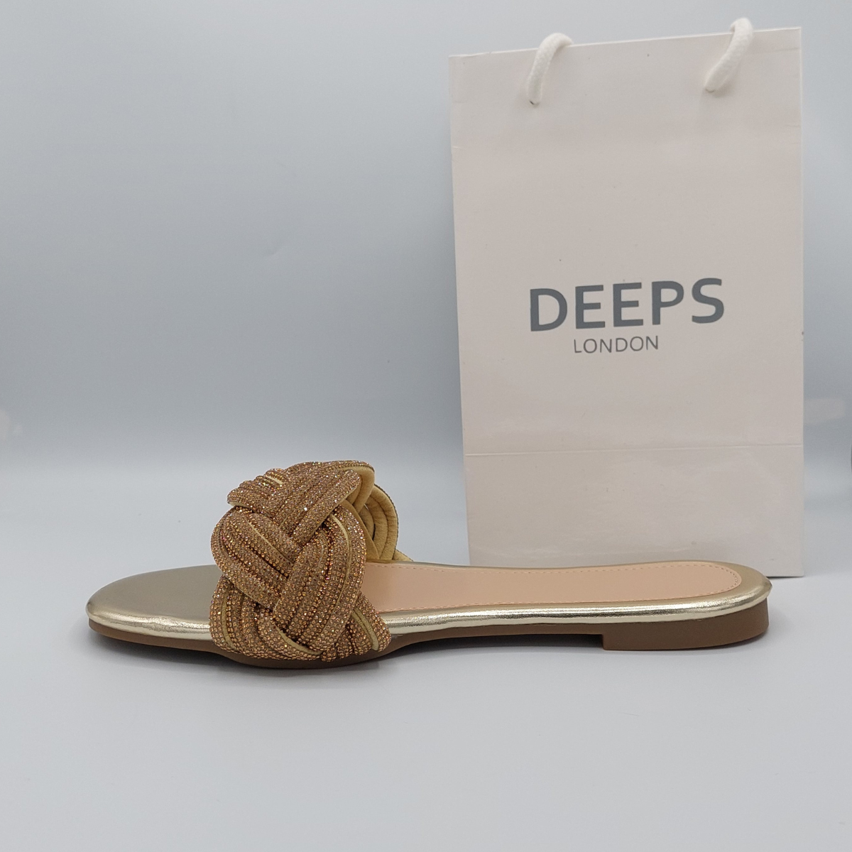 Side profile of gold perspex flat slider sandals for women showcasing the diamante embellishments.