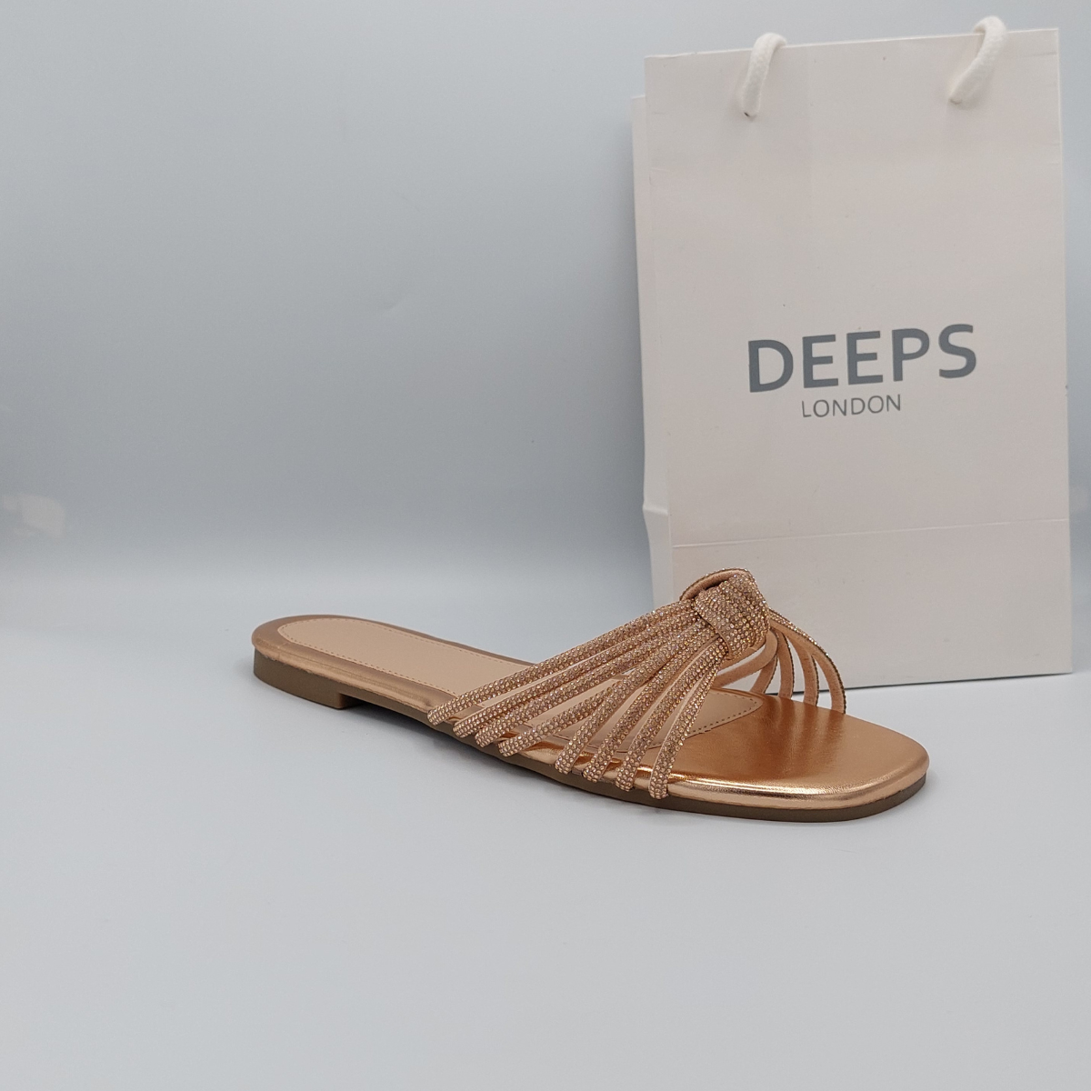 Front view of women's rose gold perspex flat slider sandals with dazzling diamante straps, perfect for a stylish look in London.