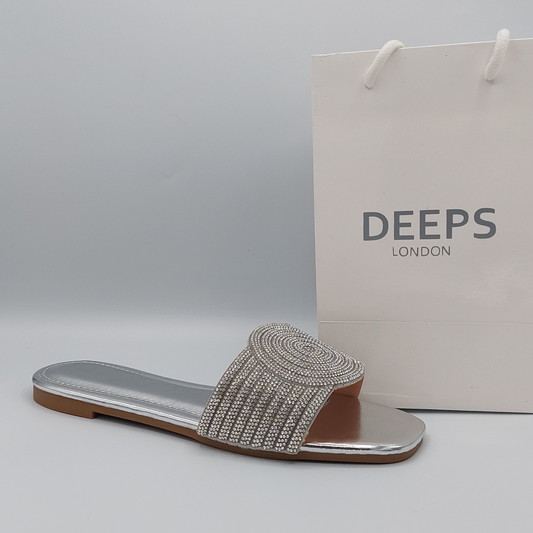 Front view of women's silver perspex flat slider sandals with elegant diamante straps, ideal for London style.