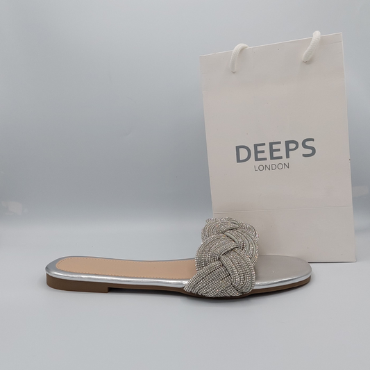 Side profile of silver perspex flat slider sandals for women showcasing the diamante embellishments.