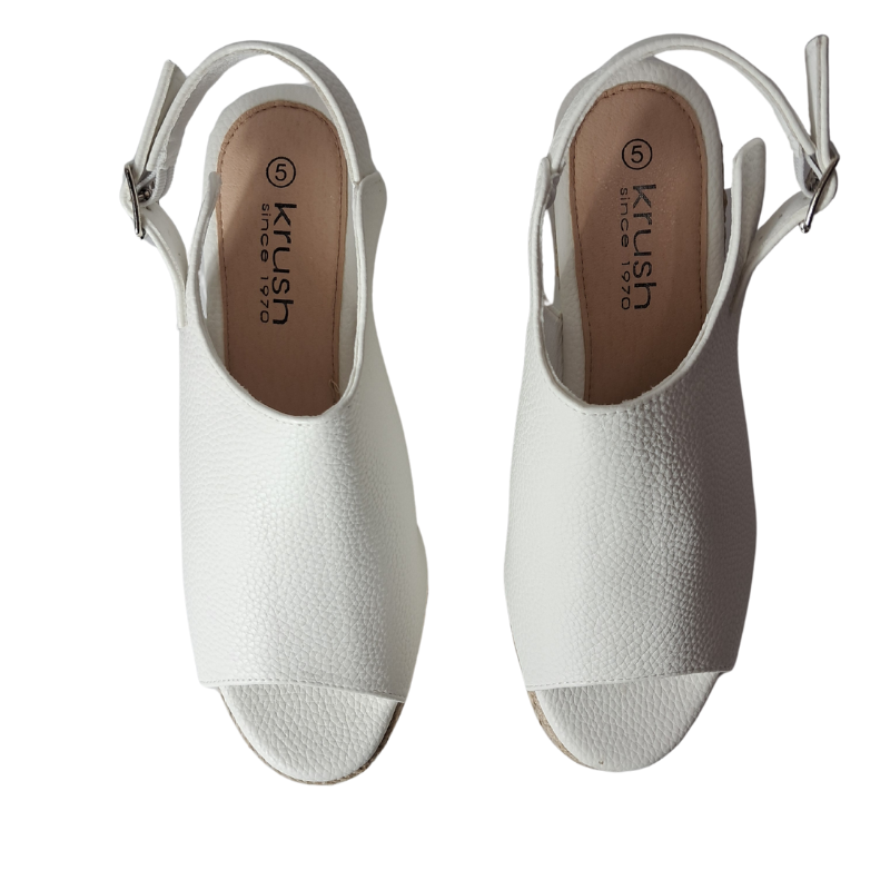 Woman's foot wearing stylish women's wedge heel peep toe sandal in white raffia styles, a fashionable choice for London outings from DeepsLondon.