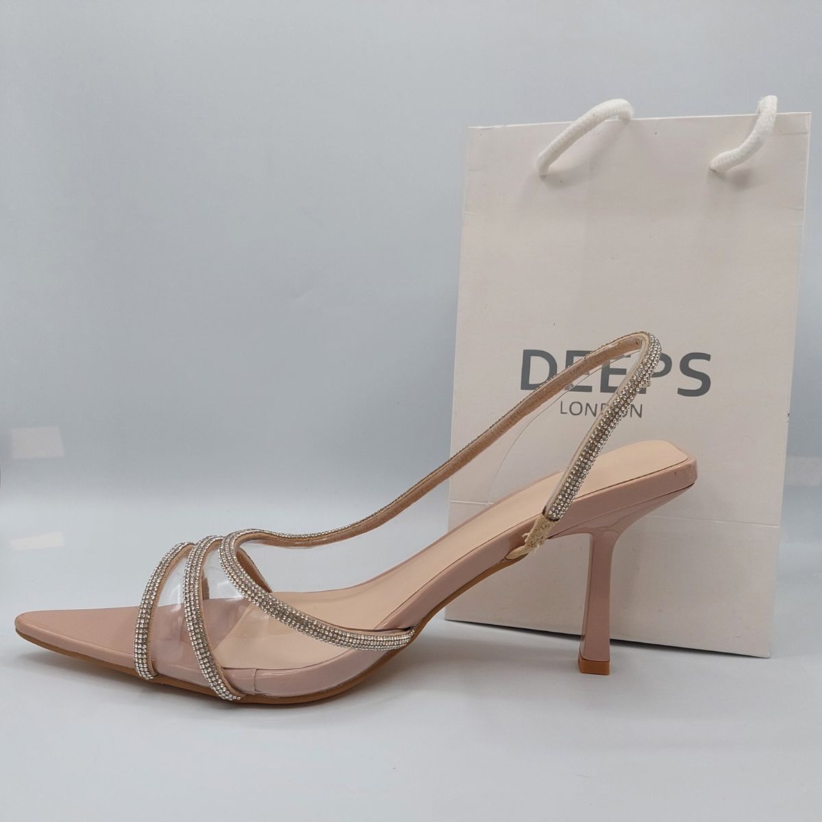 Close-up of the shiny rhinestone embellishments and clear perspex material on women's slingback stiletto heels, highlighting their elegant features from DeepsLondon.
