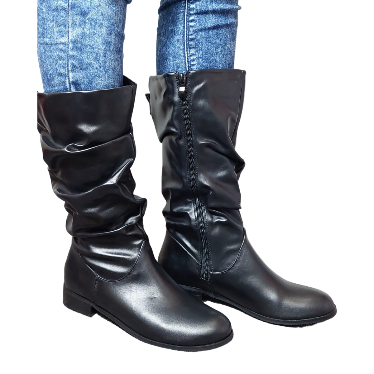 Woman's leg wearing stylish black PU ruched knee high boots with a side zip, a confident footwear choice for London life.