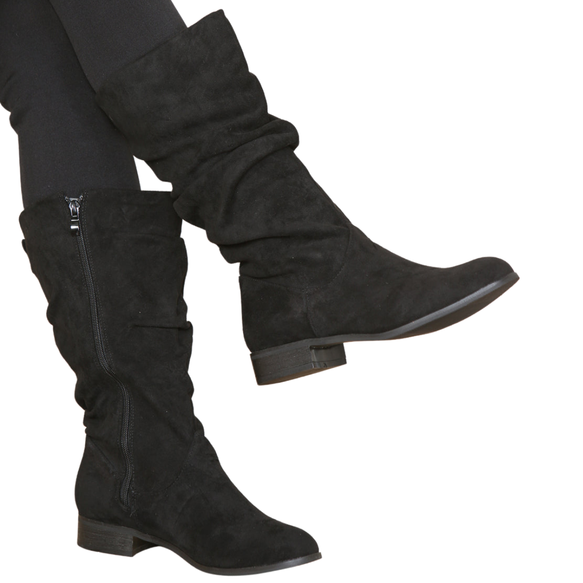 Woman's leg wearing stylish black suede ruched knee high boots with a side zip, a comfortable and fashionable choice for London life.