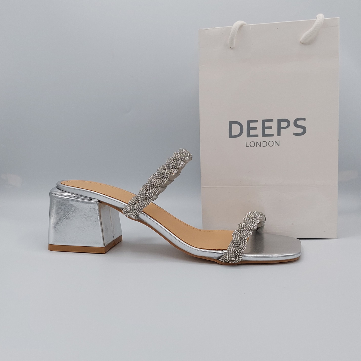 Side profile of Deeps London silver plaited gemstone band block heel mule, showcasing the block heel and plaited gemstone strap detailing.