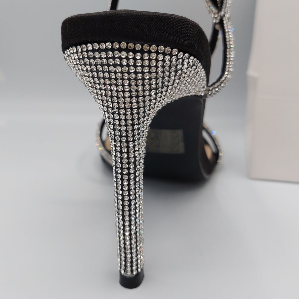 Close-up of the diamante embellishments on the straps of women's stiletto heel sandals in black, highlighting their elegant features from DeepsLondon.