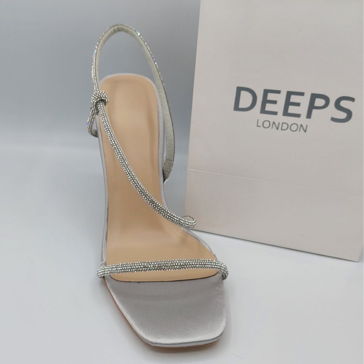 Close-up of the diamante embellishments on the straps of women's stiletto heel sandals in silver, highlighting their elegant features from DeepsLondon.