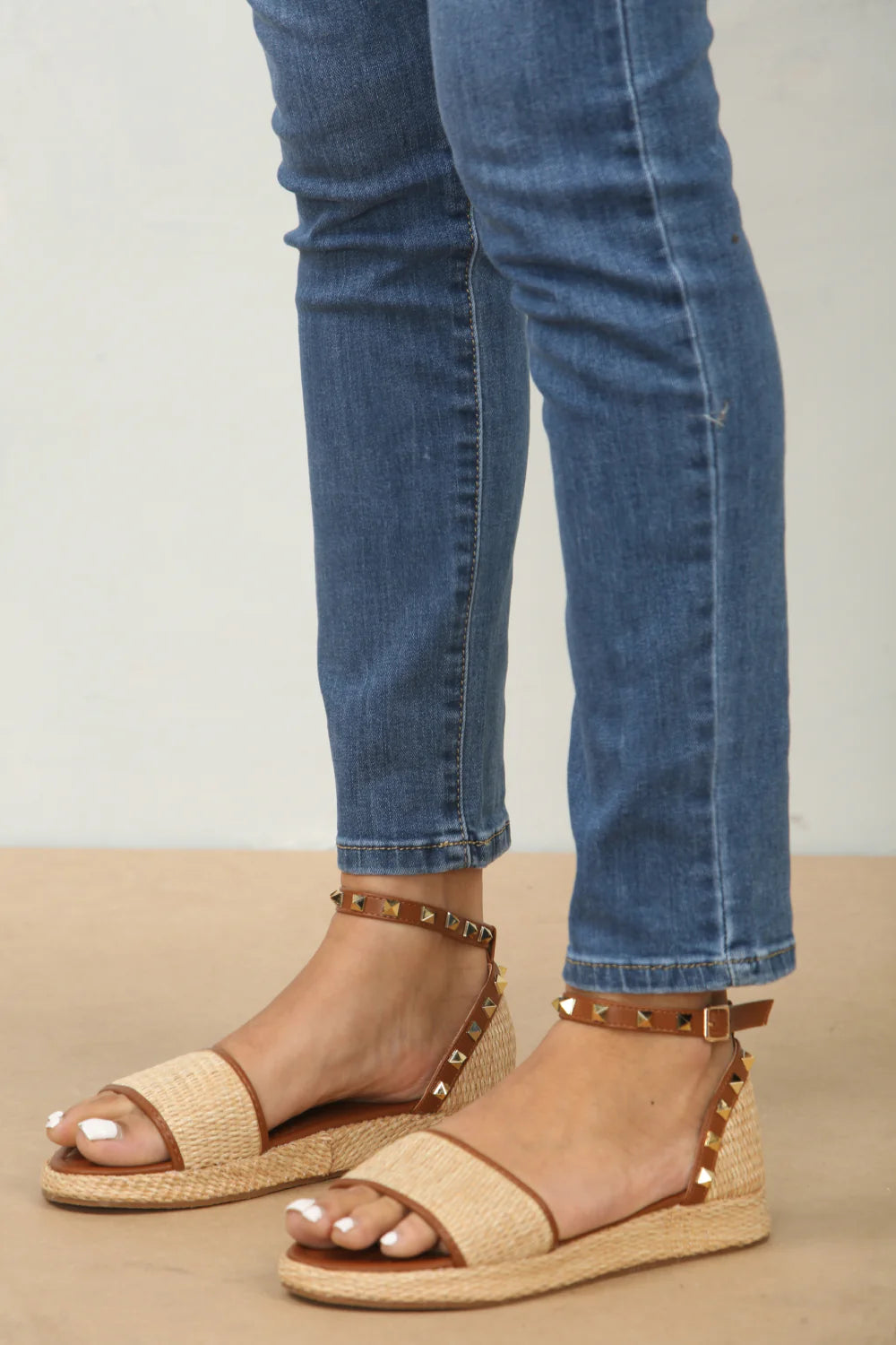 Side profile of studded raffia closed back ankle strap sandals in tan, highlighting the comfortable heel and stylish strap design, London boho-chic fashion from DeepsLondon.